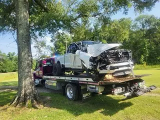 Black classic Chevelle muscle car secured on Car Wars flatbed in Orange, TX