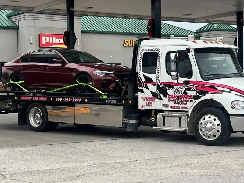 Car Wars flatbed transporting a BMW M5 at Pilot truck stop in Orange, TX