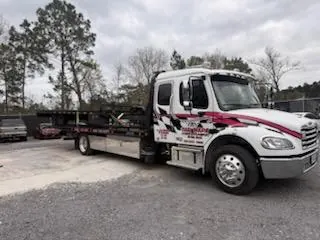 Car Wars flatbed transporting a silver Maserati Quattroporte in Orange, TX