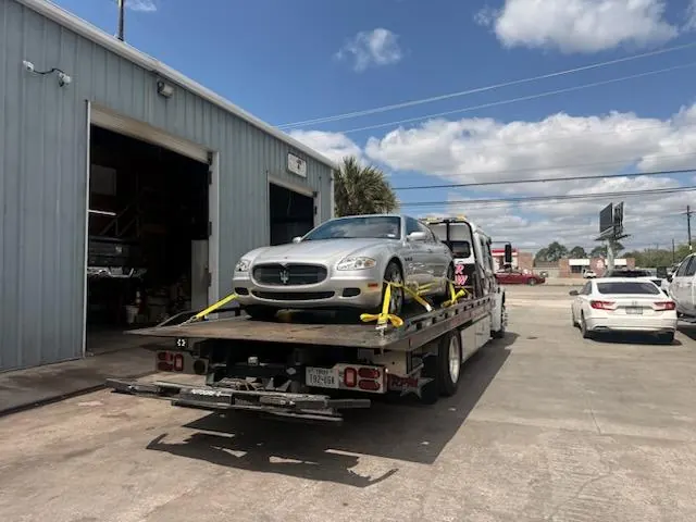 Car Wars Towing fleet with motorcycle at company yard, Orange, TX