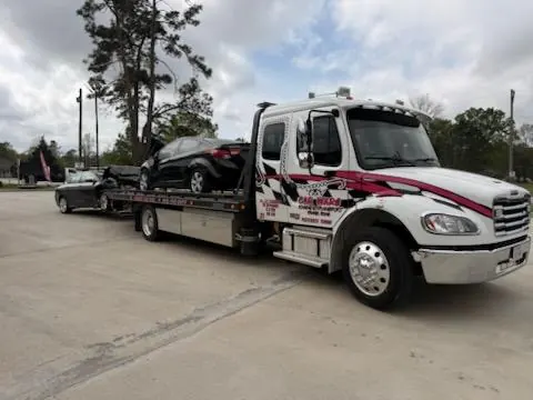 Pink Car Wars wrecker towing an RV in Orange, TX